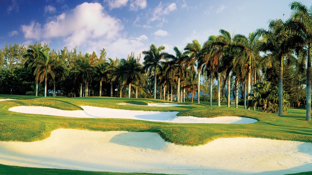 Palm-lined fairway and sand bunkers on the Half Moon golf course in Montego Bay, Jamaica