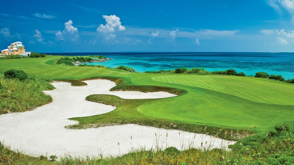 Oceanfront fairway and bunkers on the Greg Norman golf course at Sandals Emerald Bay, Great Exuma